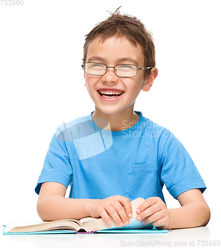 Image of Little boy is reading a book