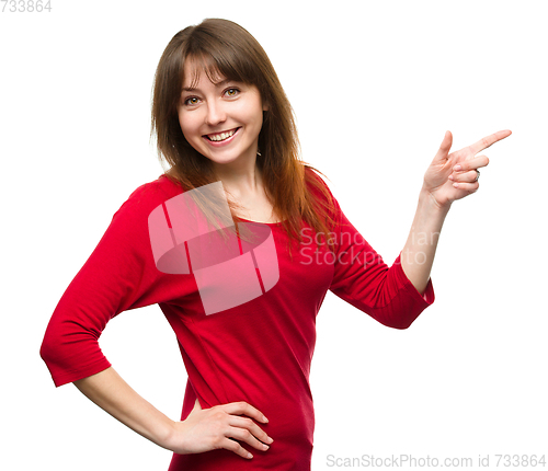 Image of Portrait of a young woman pointing to the right