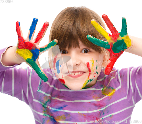 Image of Portrait of a cute girl playing with paints