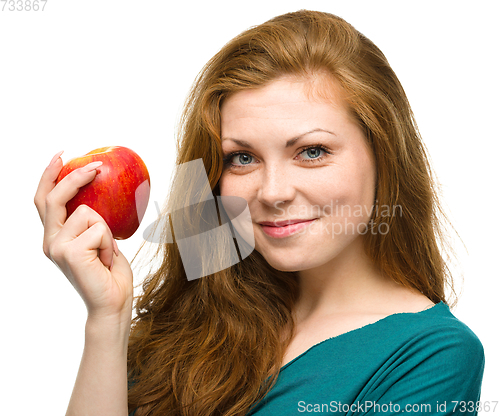 Image of Young happy girl with apple