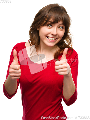 Image of Woman is showing thumb up gesture