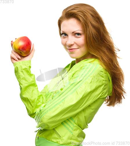 Image of Young happy girl with apple