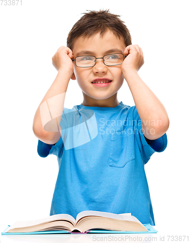 Image of Little boy is reading a book