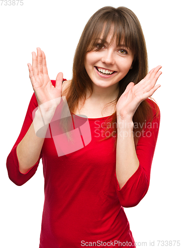 Image of Portrait of a young woman raised her hands up