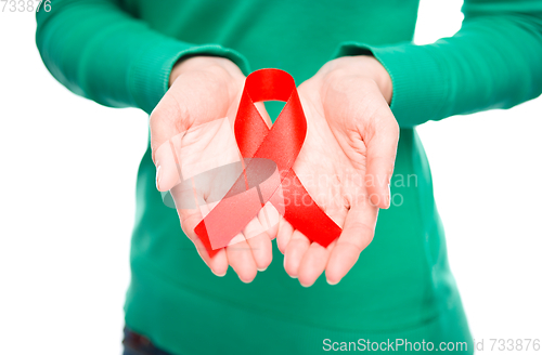 Image of Woman is holding the red awareness ribbon