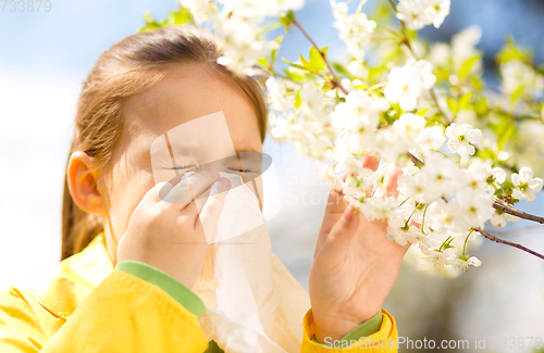 Image of Little girl is blowing her nose