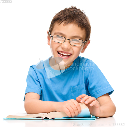 Image of Little boy is reading a book