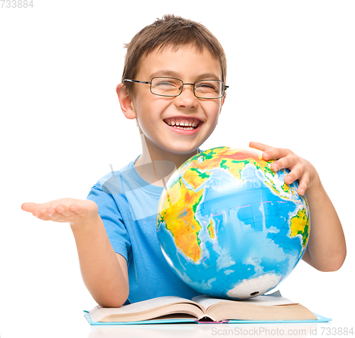 Image of Little boy is holding globe