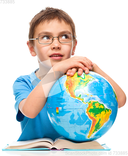 Image of Little boy is holding globe