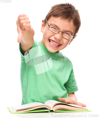 Image of Little boy is reading a book