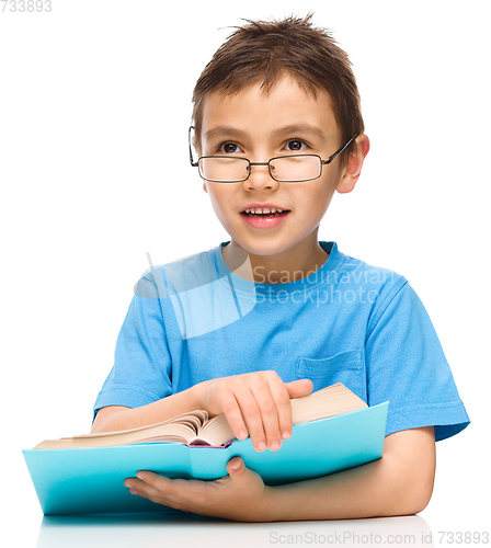 Image of Little boy is reading a book