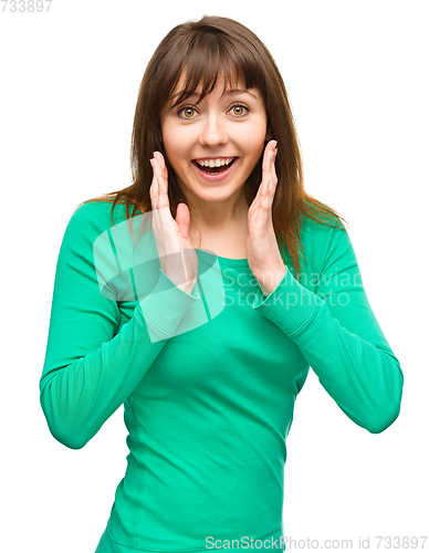 Image of Woman is holding her face in astonishment