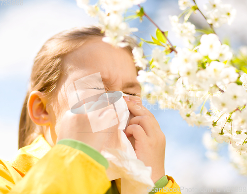 Image of Little girl is blowing her nose