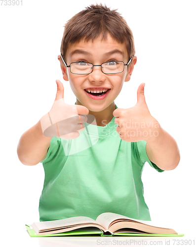 Image of Little boy is reading a book
