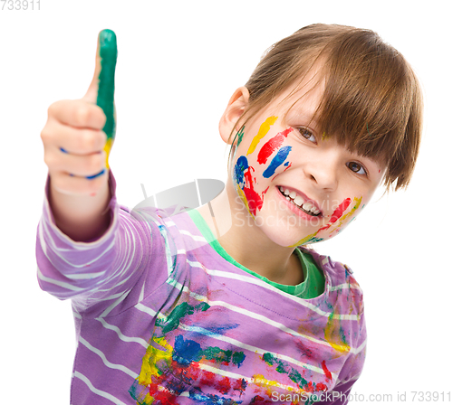 Image of Portrait of a cute girl playing with paints