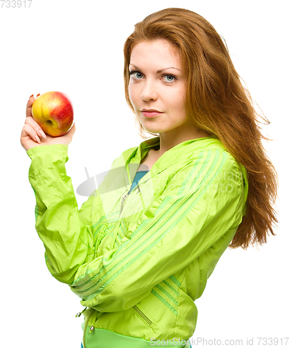 Image of Young happy girl with apple