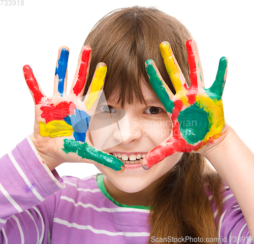 Image of Portrait of a cute girl playing with paints