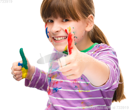 Image of Portrait of a cute girl playing with paints