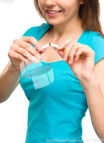 Image of Young woman is breaking a cigarette