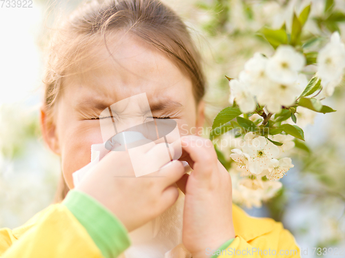 Image of Little girl is blowing her nose