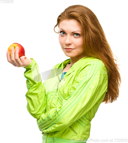 Image of Young happy girl with apple