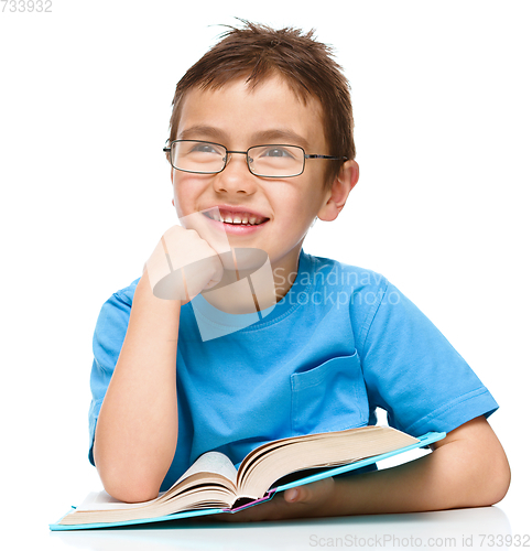 Image of Little boy is reading a book