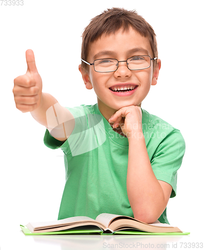 Image of Little boy is reading a book