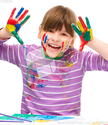 Image of Portrait of a cute girl playing with paints