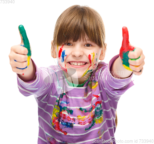 Image of Portrait of a cute girl playing with paints