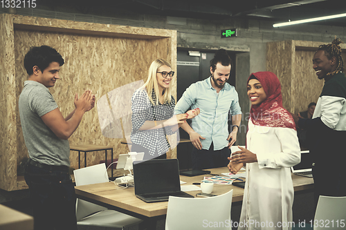 Image of multiethnic Group of young business people celebrating success