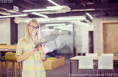 Image of blonde businesswoman working online using digital tablet