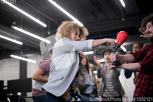 Image of multiethnics business team boxing at office