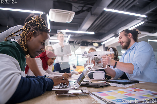 Image of multiethnic business team learning about drone technology