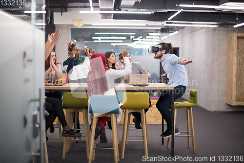 Image of Young Multiethnic Business team using virtual reality headset
