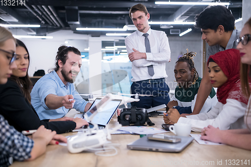 Image of multiethnic business team learning about drone technology