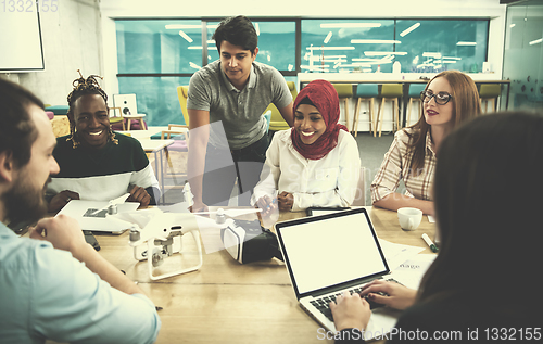 Image of multiethnic business team learning about drone technology