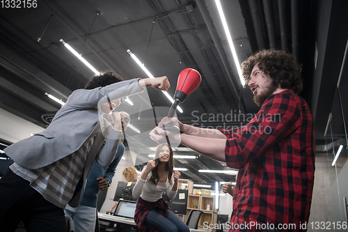 Image of multiethnics business team boxing at office