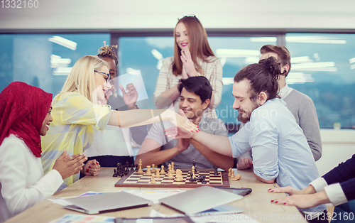 Image of multiethnic group of business people playing chess