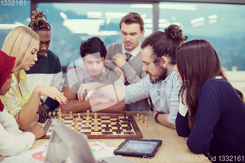 Image of multiethnic group of business people playing chess