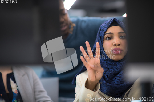 Image of black muslim female software developer at work