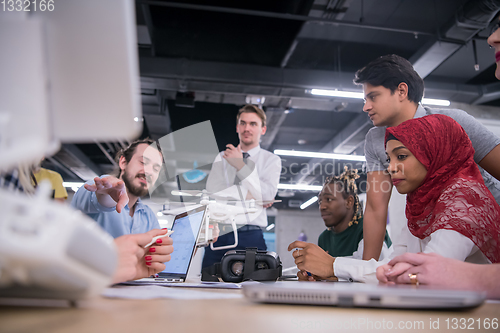 Image of multiethnic business team learning about drone technology