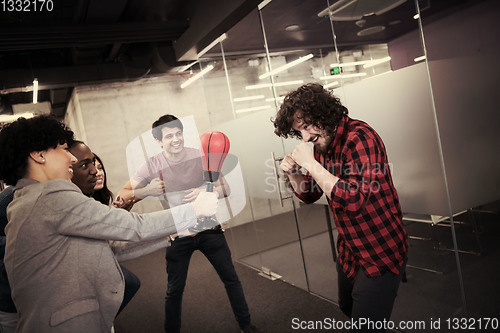 Image of multiethnics business team boxing at office