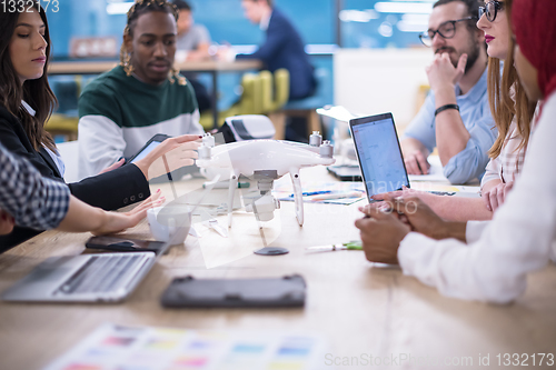 Image of multiethnic business team learning about drone technology