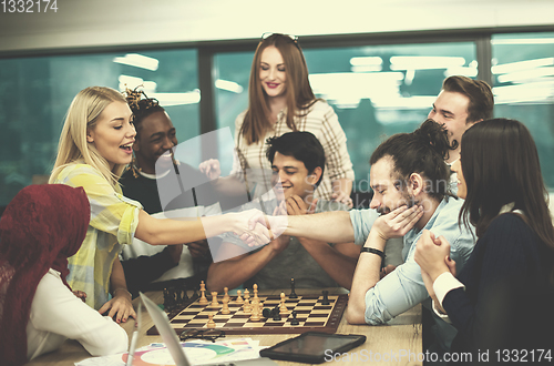 Image of multiethnic group of business people playing chess