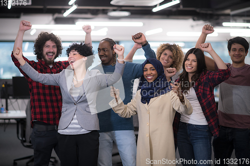 Image of portrait of young excited multiethnics business team