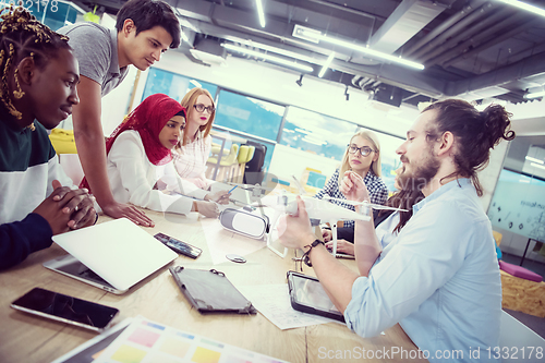 Image of multiethnic business team learning about drone technology