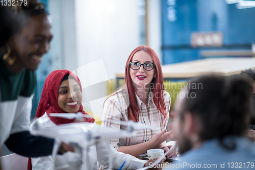 Image of multiethnic business team learning about drone technology