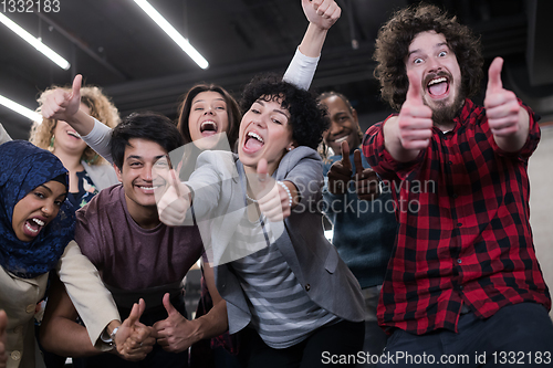 Image of portrait of young excited multiethnics business team
