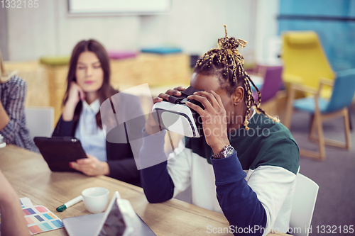 Image of Young Multiethnic Business team using virtual reality headset