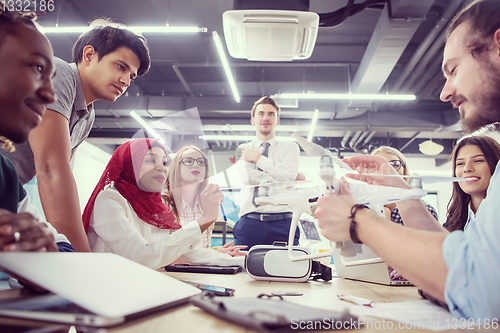 Image of multiethnic business team learning about drone technology